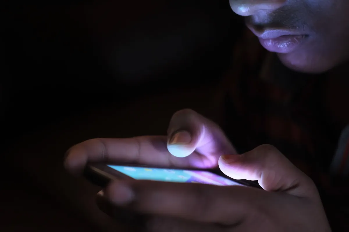A person using a smartphone to browse an online service.