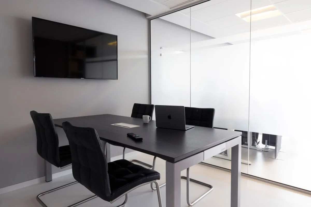 A television mounted inside a modern office meeting room, showing an ordinary location where concealed electronic equipment could be overlooked.