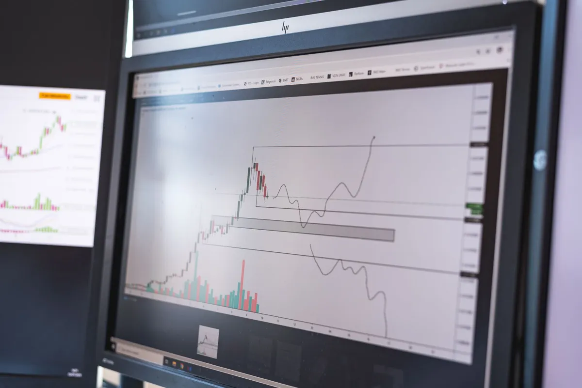 Traders working at computer terminals illustrate the wider market reaction to technology company earnings.